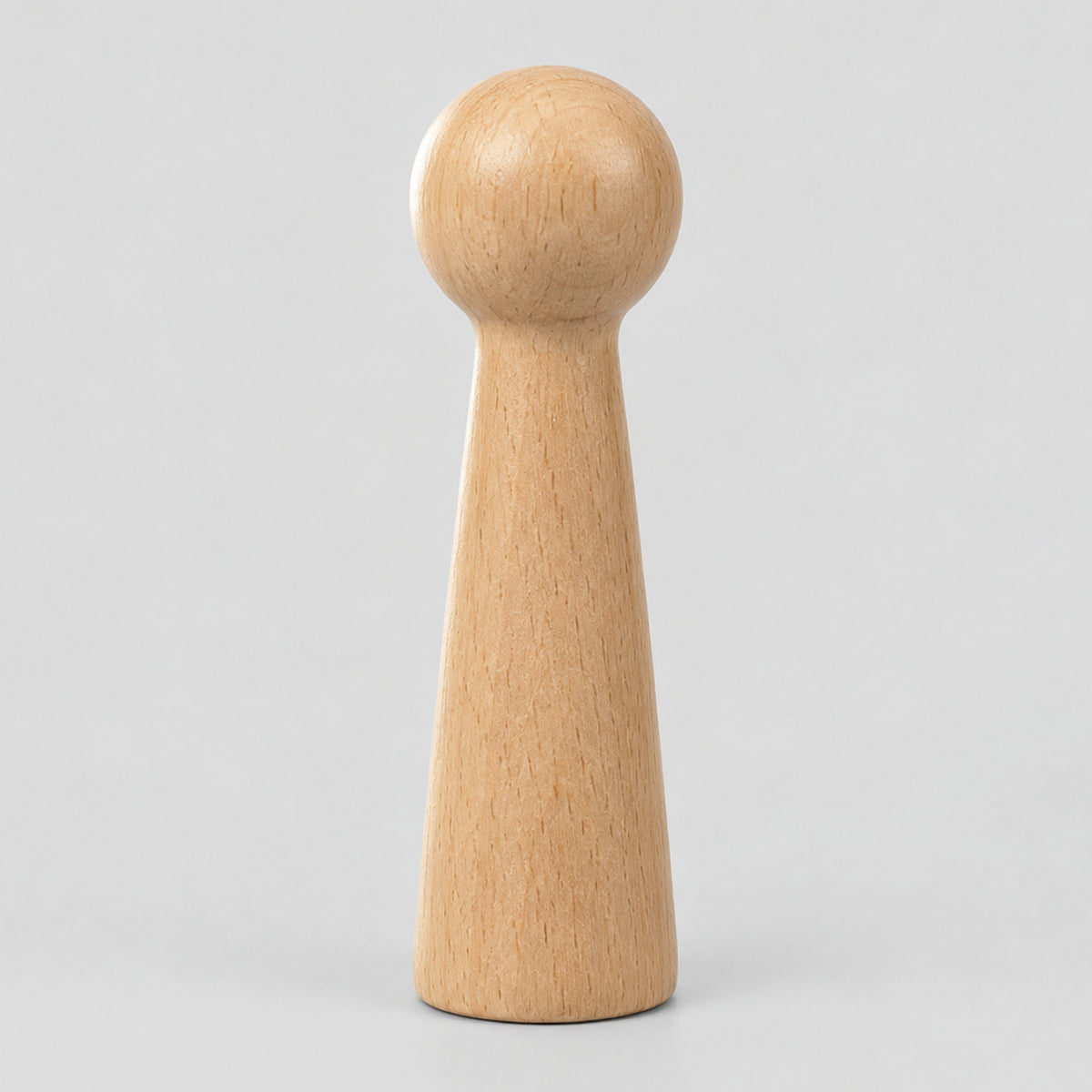 Turned beech wood wall peg in Natural Beech on a light gray studio background.