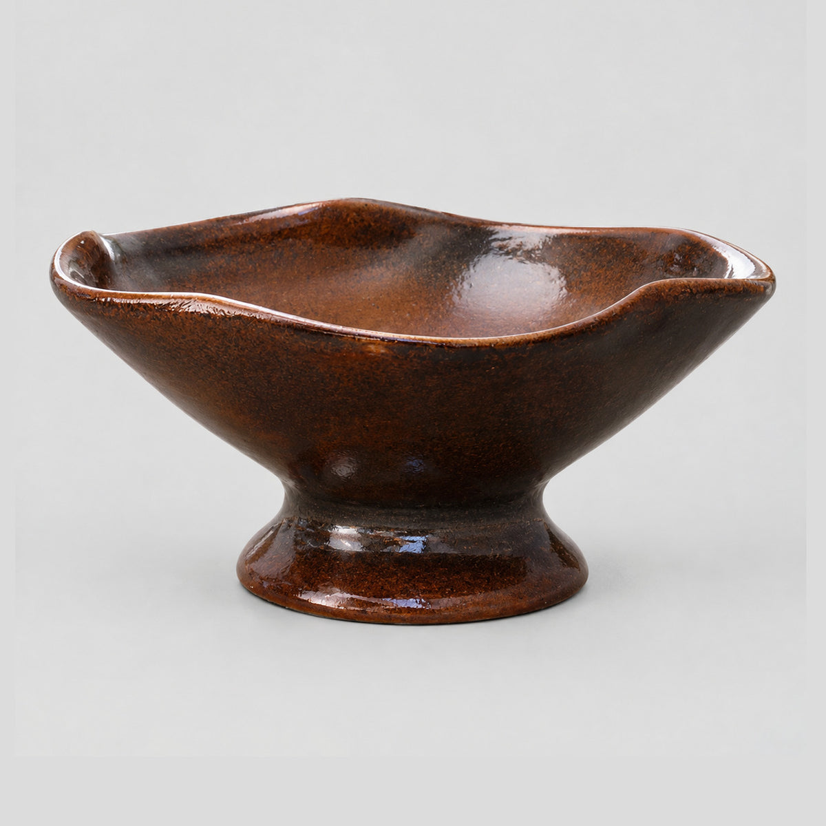 Ceramic footed planter bowl in Glazed Brown on a light gray studio background.