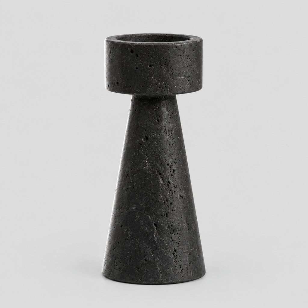 Travertine stone candle holder in Black Travertine on a light gray studio background
