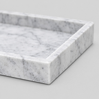 Close up of the raised rim along the border of the Cloud White rectangular marble vanity tray.