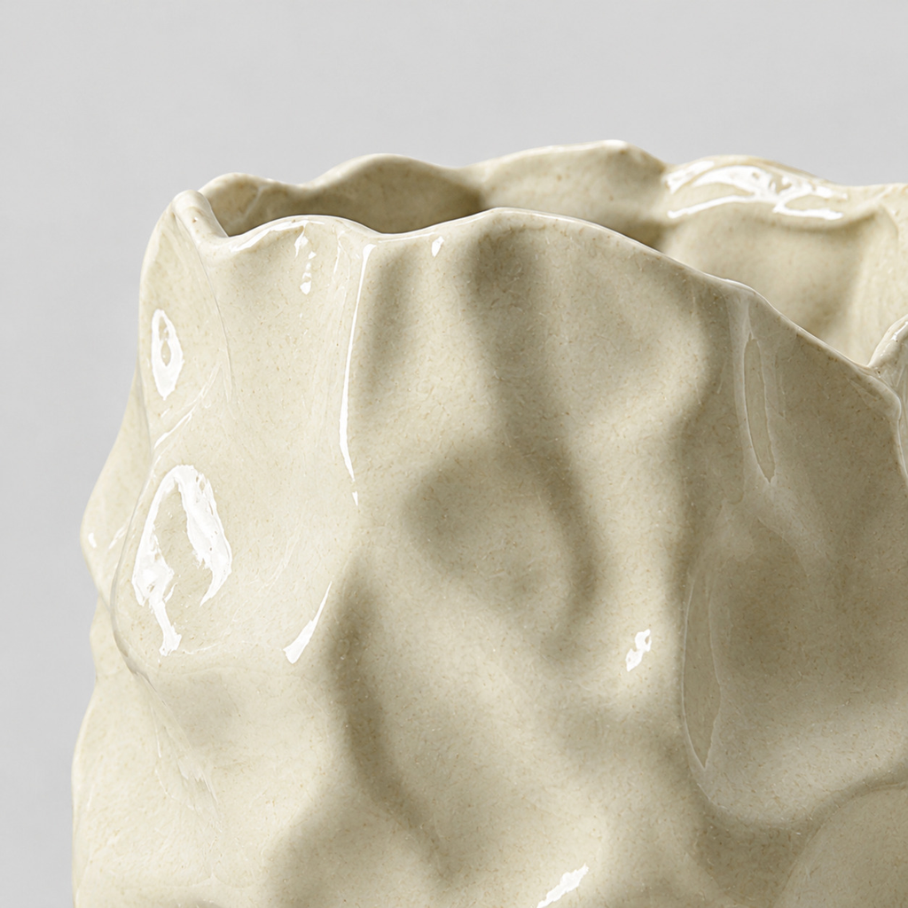 Close up of the glaze or surface texture of the cream crinkled ceramic vase.