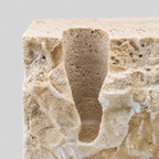 Close up of the porous stone surface texture of the travertine candle holder