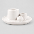 White ceramic incense and candle tray on a light gray studio background