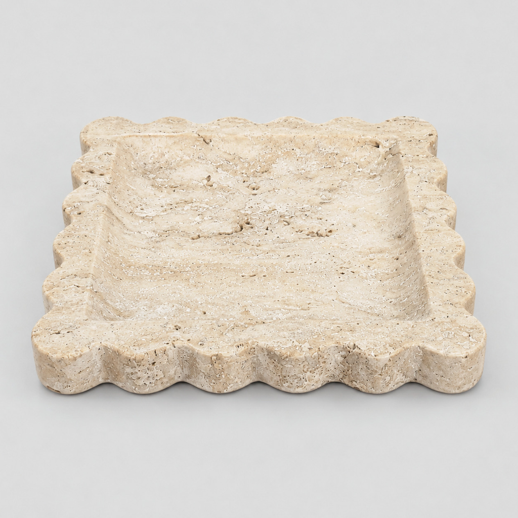 Scalloped square stone tray in Yellow Travertine on a light gray studio background.
