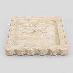 Scalloped square stone tray in Yellow Travertine on a light gray studio background.