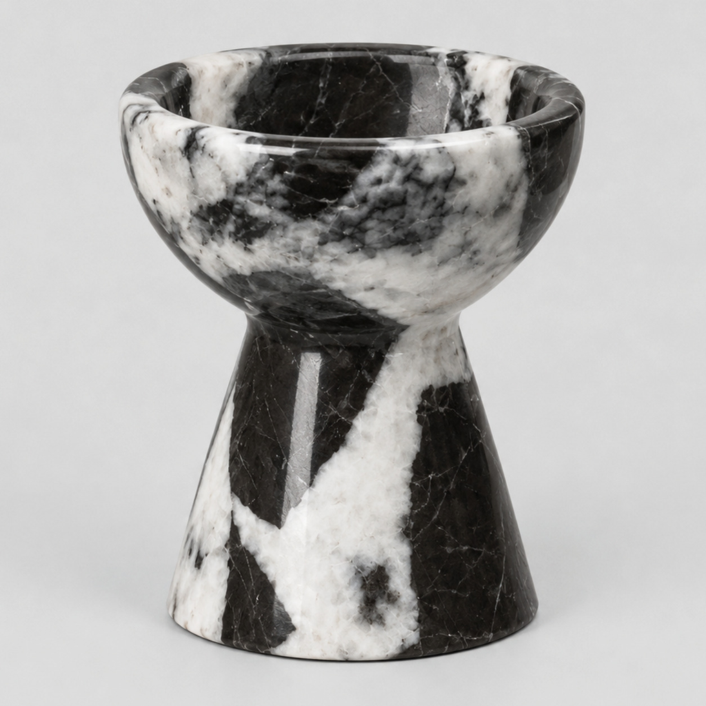 Pedestal marble candle holder in Black Marble on a light gray studio background.