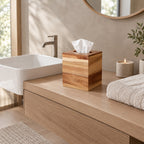 Square acacia wood tissue box cover on a 90 cm wide bathroom vanity beside a folded towel with a tissue emerging from the top