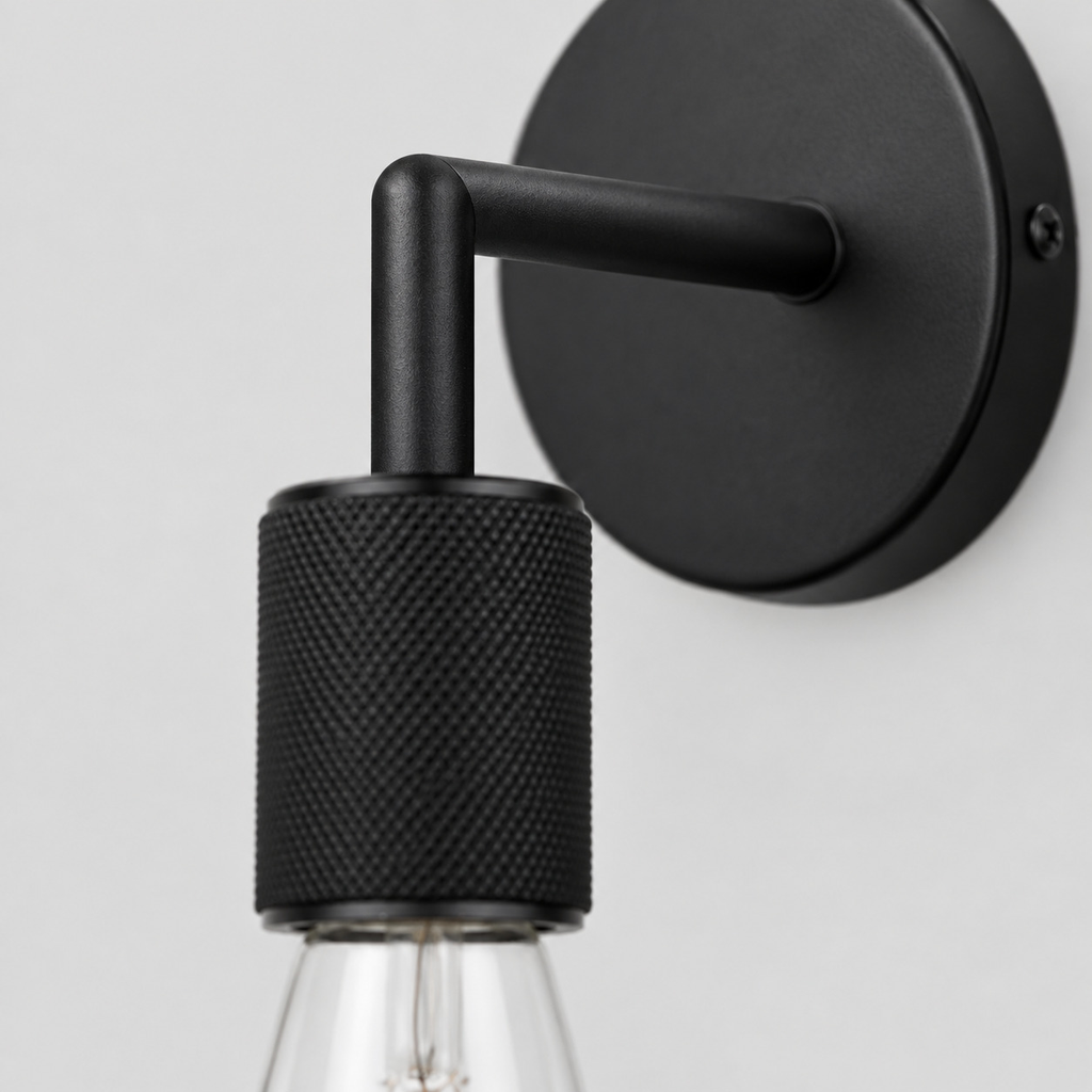 Close up of the arm joint of the Matte Black knurled socket wall sconce