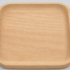 Close up of the smooth sanded natural beech wood grain surface texture of the natural beech wood rounded square serving tray