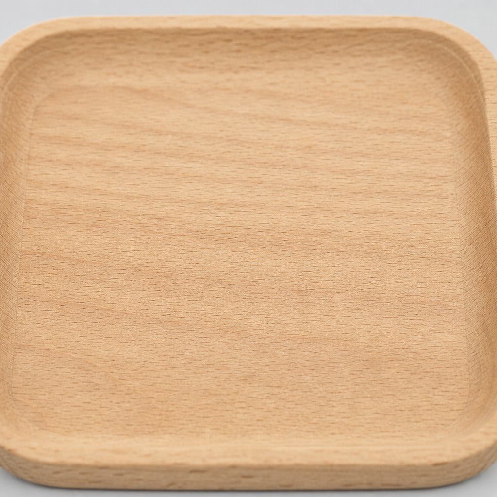 Close up of the smooth sanded natural beech wood grain surface texture of the natural beech wood rounded square serving tray