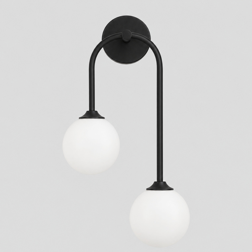 Matte Black asymmetric double-globe arch wall sconce switched off on a light gray studio background.