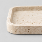 Close up of the smooth rounded rim of the rectangular travertine catchall tray in Beige Travertine.