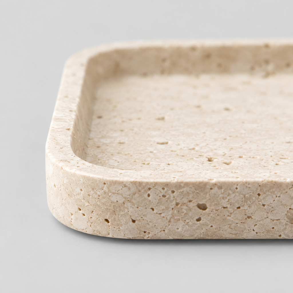 Close up of the smooth rounded rim of the rectangular travertine catchall tray in Beige Travertine.