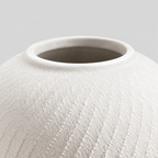 Close up of the smooth circular rim of the textured ceramic vase in Matte White.
