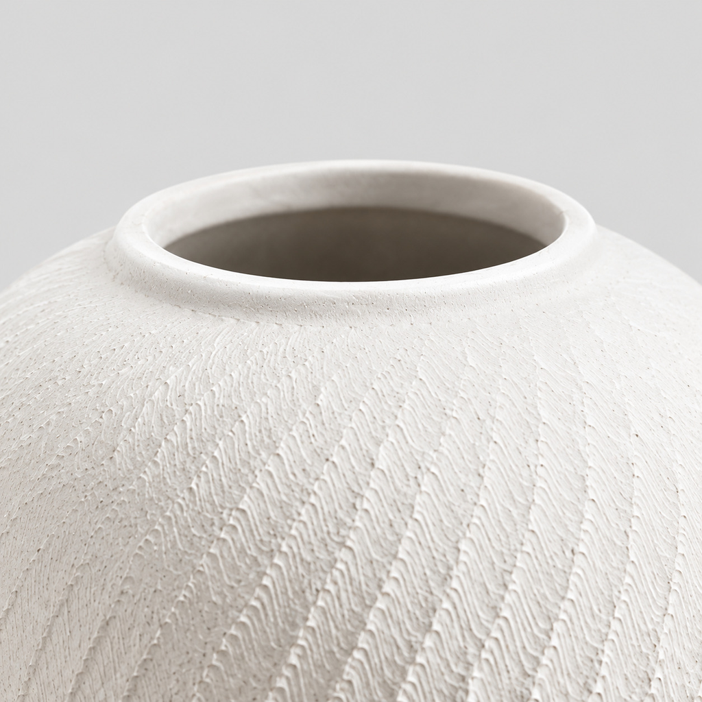 Close up of the smooth circular rim of the textured ceramic vase in Matte White.