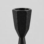 Close up of the faceted rim of the candle cup of the set of two faceted cast iron taper candle holders