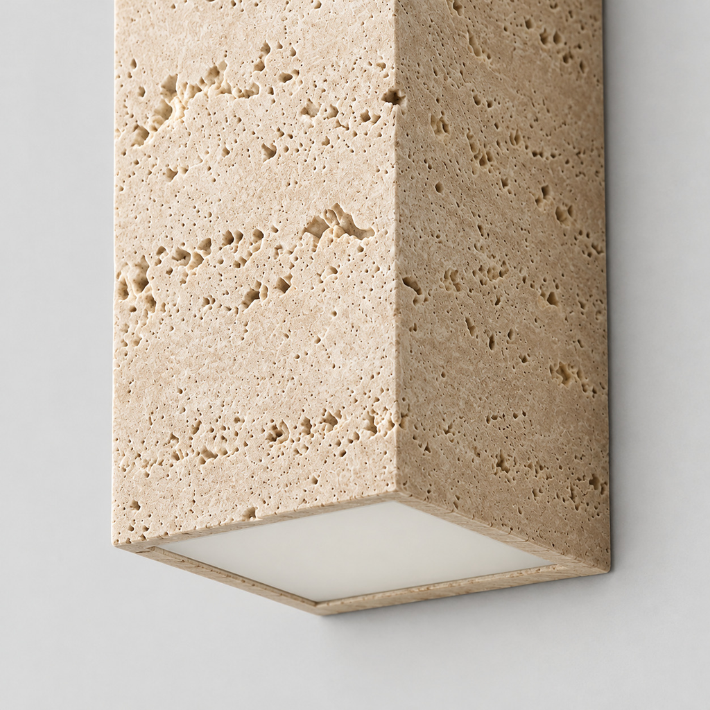 Close up of the acrylic diffuser panel at the base of the travertine block wall sconce