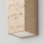 Close up of the acrylic diffuser panel at the base of the travertine block wall sconce