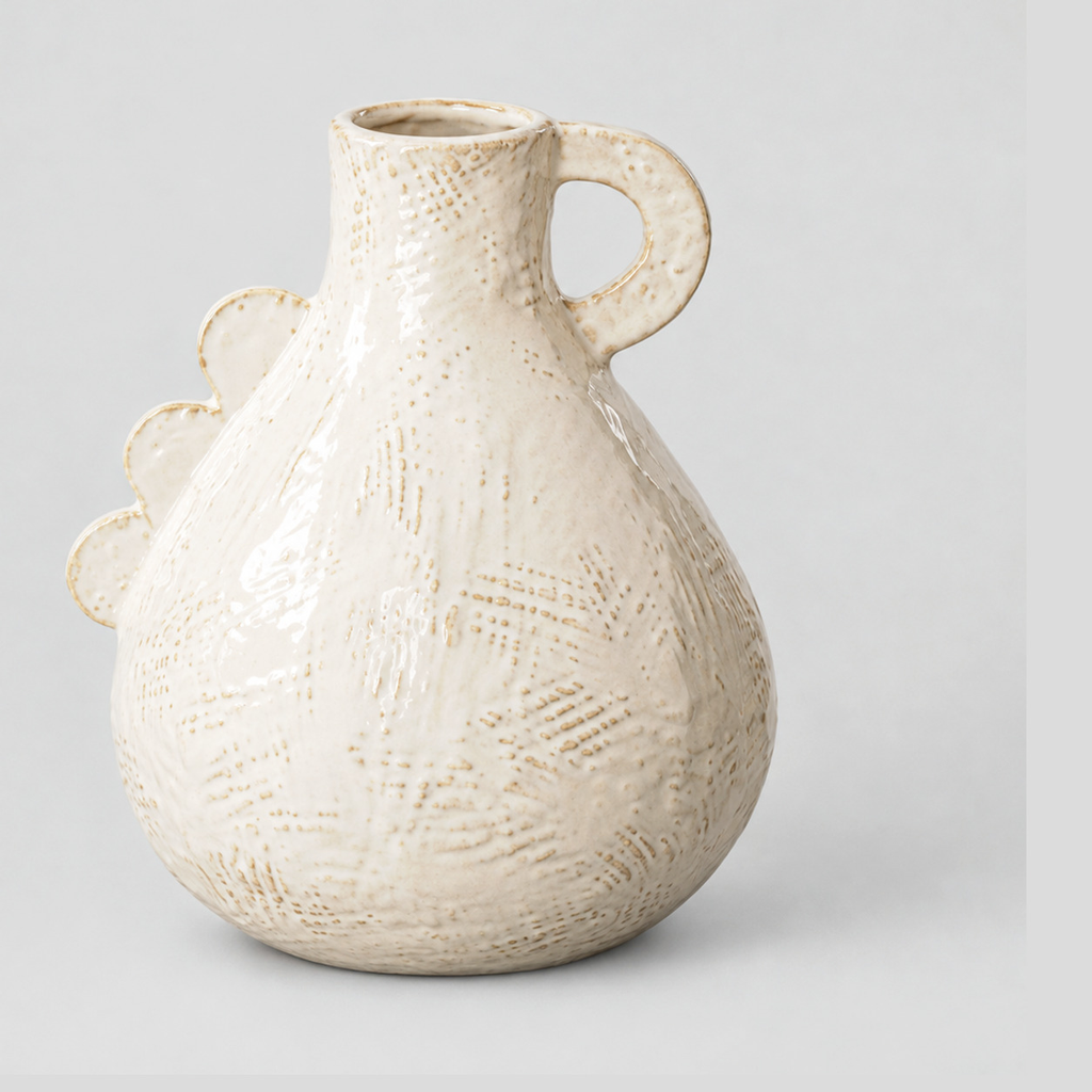 Off-white scalloped ceramic vase on a light gray studio background