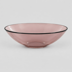 Shallow glass bowl with black rim in Blush on a light gray studio background.