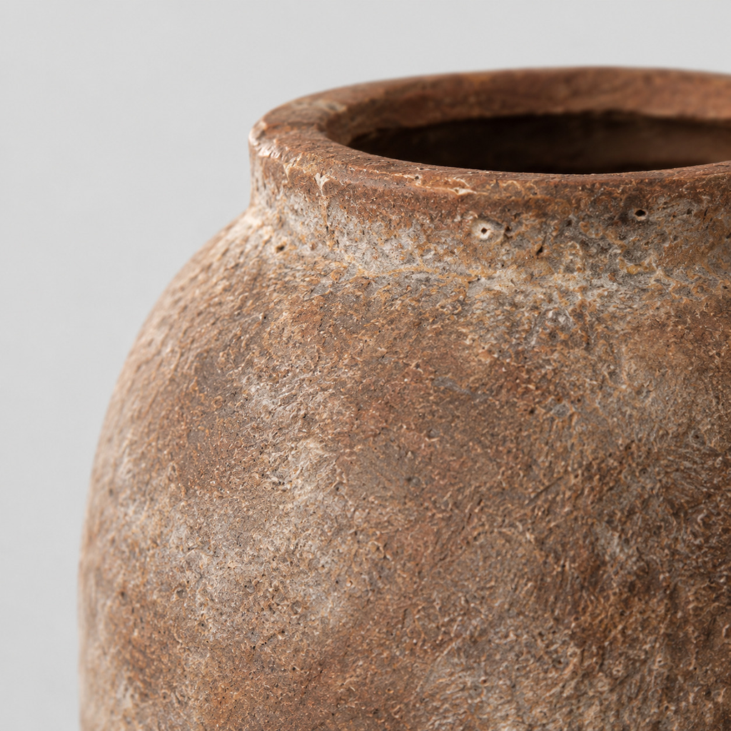 Close up of the mottled stoneware surface texture of the weathered ceramic vase in Dark Brown.