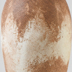 Close up of the weathered mottled glaze on the vase body of the textured ceramic vase.