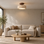 Travertine drum flush mount ceiling light lit on the ceiling above a 200 cm wide sofa