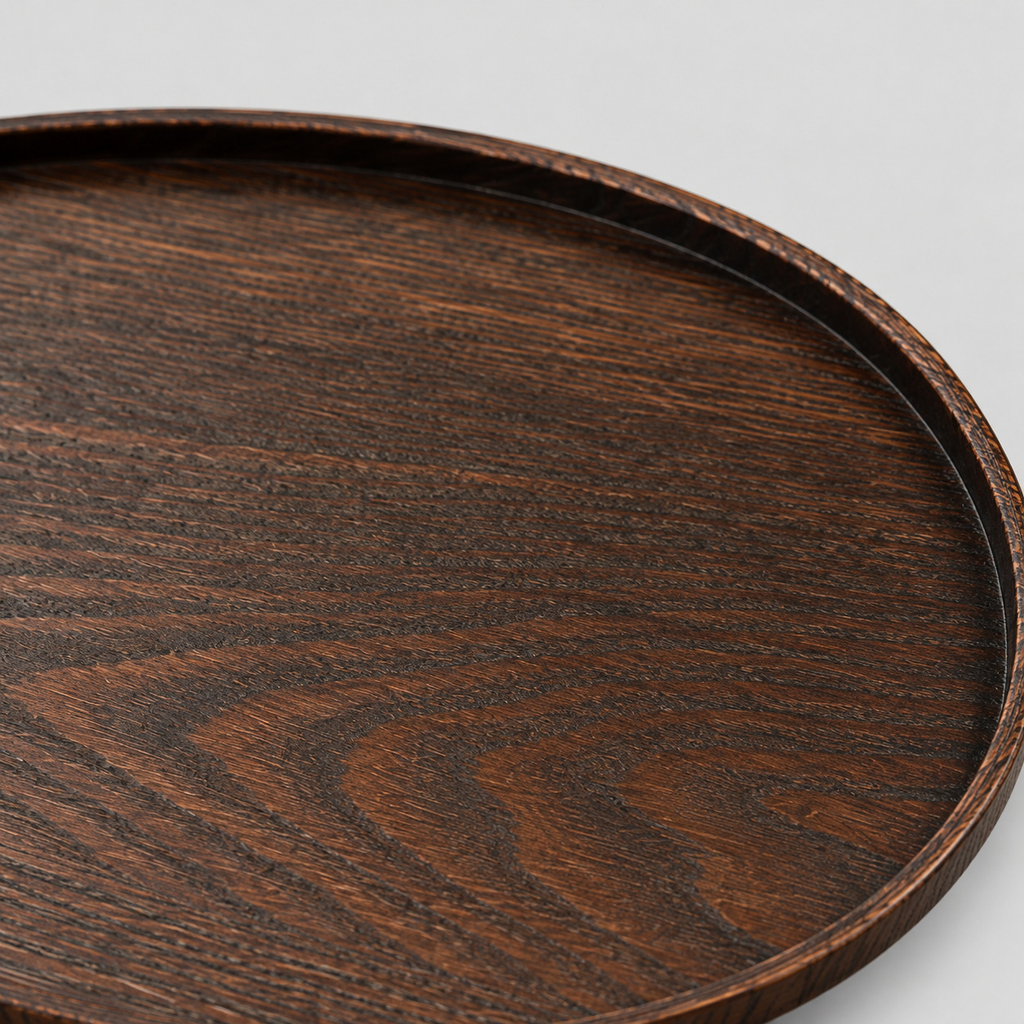 Close up of the ash wood grain texture across the oval dark ash wood serving tray