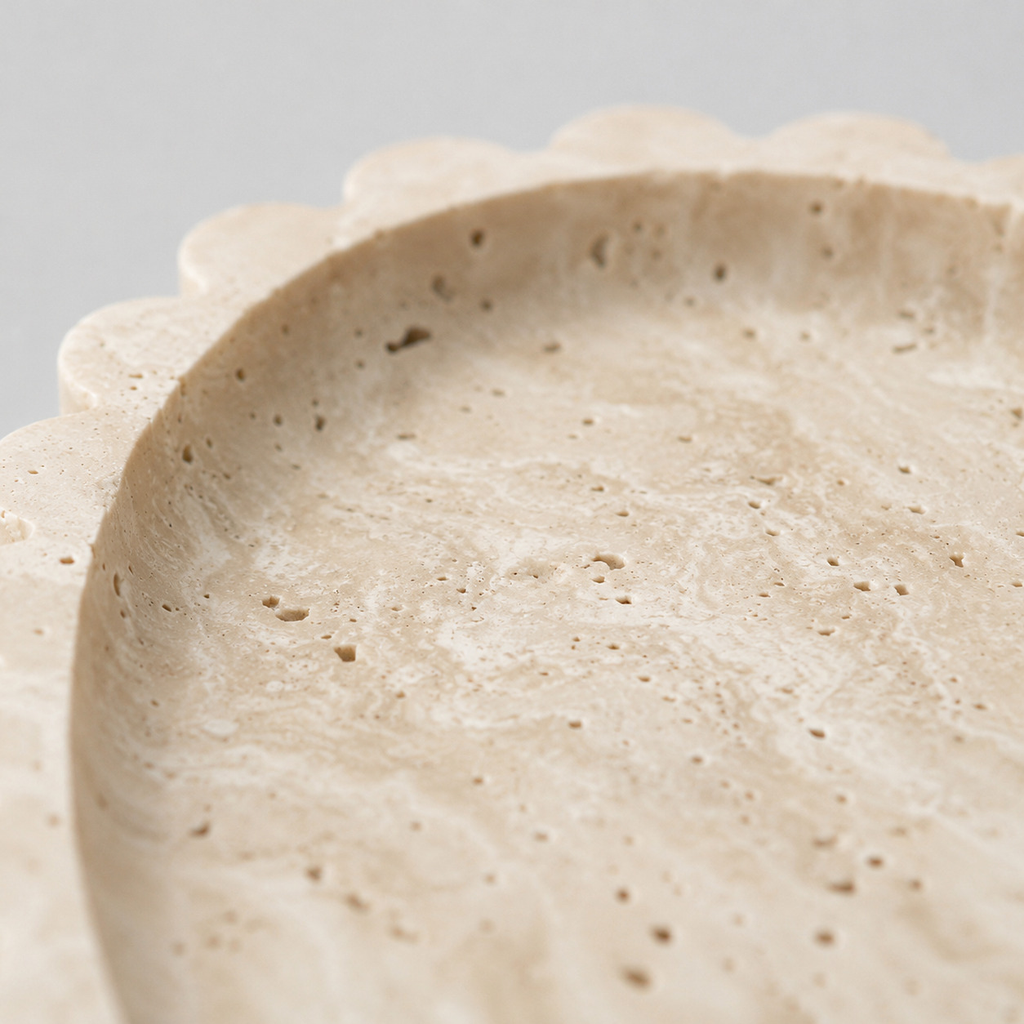 Close up of the porous natural travertine surface texture of the scalloped oval travertine tray