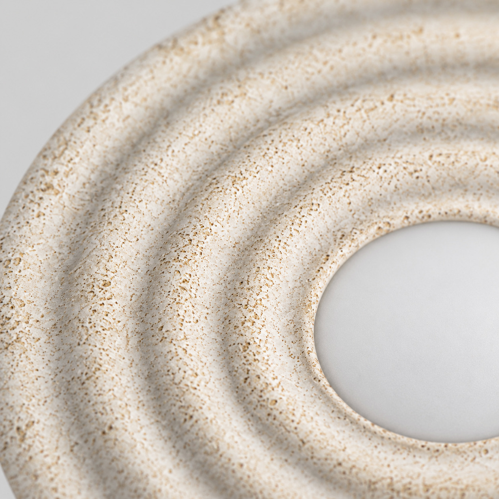 Close up of the round canopy against the wall of the Distressed White circular concentric ripple wall sconce.