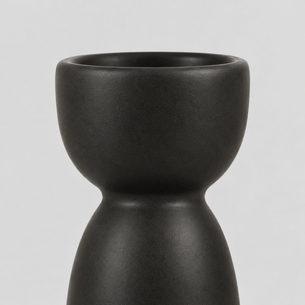 Close up of the smooth rounded cup rim of the matte ceramic taper candle holder.