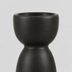 Close up of the smooth rounded cup rim of the matte ceramic taper candle holder.
