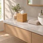 Natural woven rattan cube tissue box cover on a 90 cm wide bathroom vanity with a folded towel and tissue dispensed
