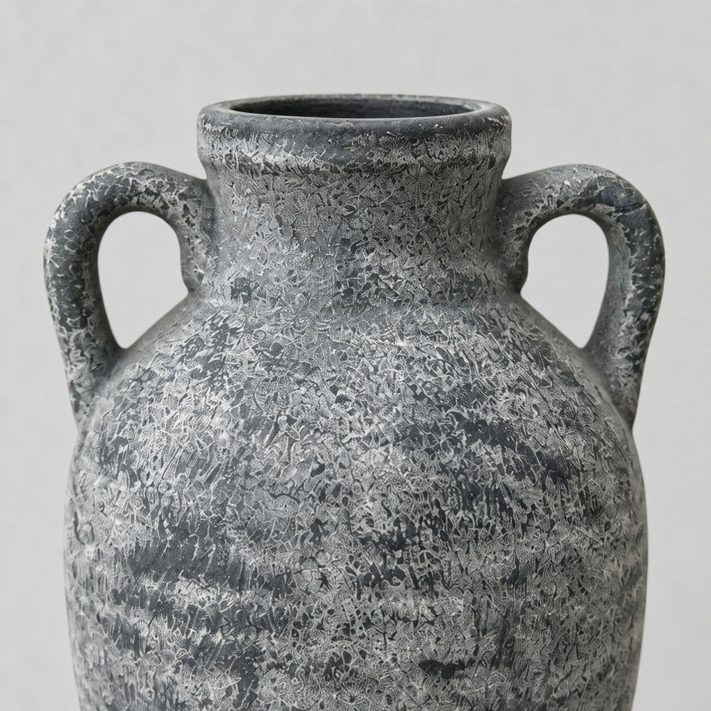 Close up of the distressed textured surface finish of the weathered gray ceramic amphora vase