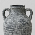 Close up of the distressed textured surface finish of the weathered gray ceramic amphora vase