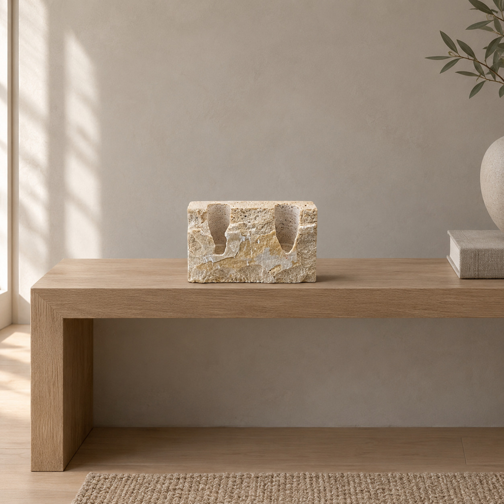 Travertine candle holder on an oak console table in a calm room