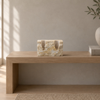 Travertine candle holder on an oak console table in a calm room