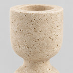 Close up of the porous stone surface texture of the travertine candle holder.