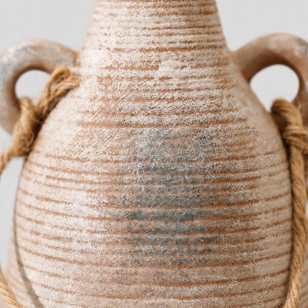 Close up of the horizontal ribbed glaze across the ceramic body of the ribbed ceramic vase in Rust.