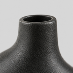 Close up of the smooth rounded rim of the shorter neck of the vase