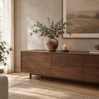 Weathered ceramic vase in Weathered Brown on a walnut sideboard with a bunch of eucalyptus in the vase.