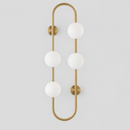 Brass pill-frame frosted globe wall sconce on a light gray studio background.