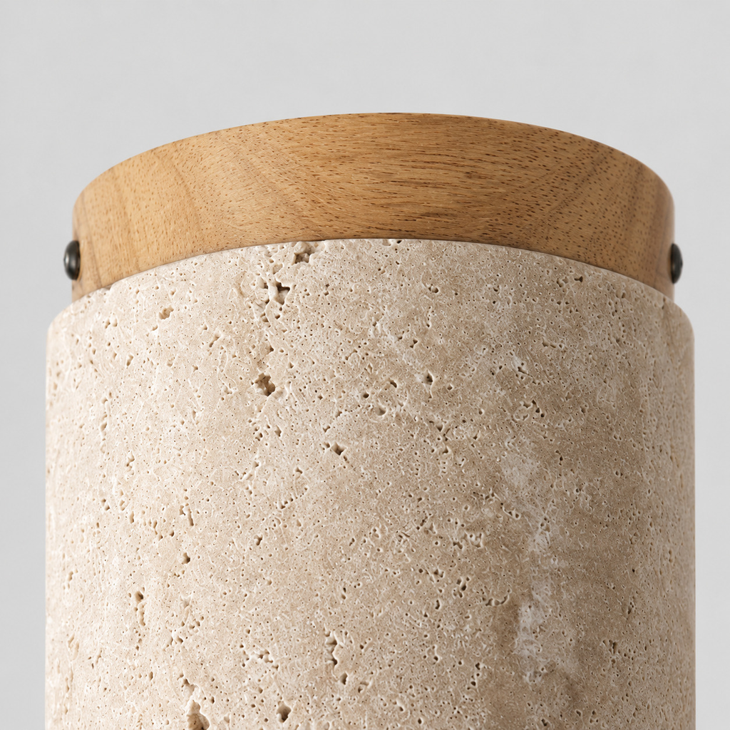 Close up of the round canopy against the wall of the cylindrical travertine ceiling light.