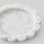 Close up of the scalloped fluted rim of the scalloped stone trinket tray in White Marble.