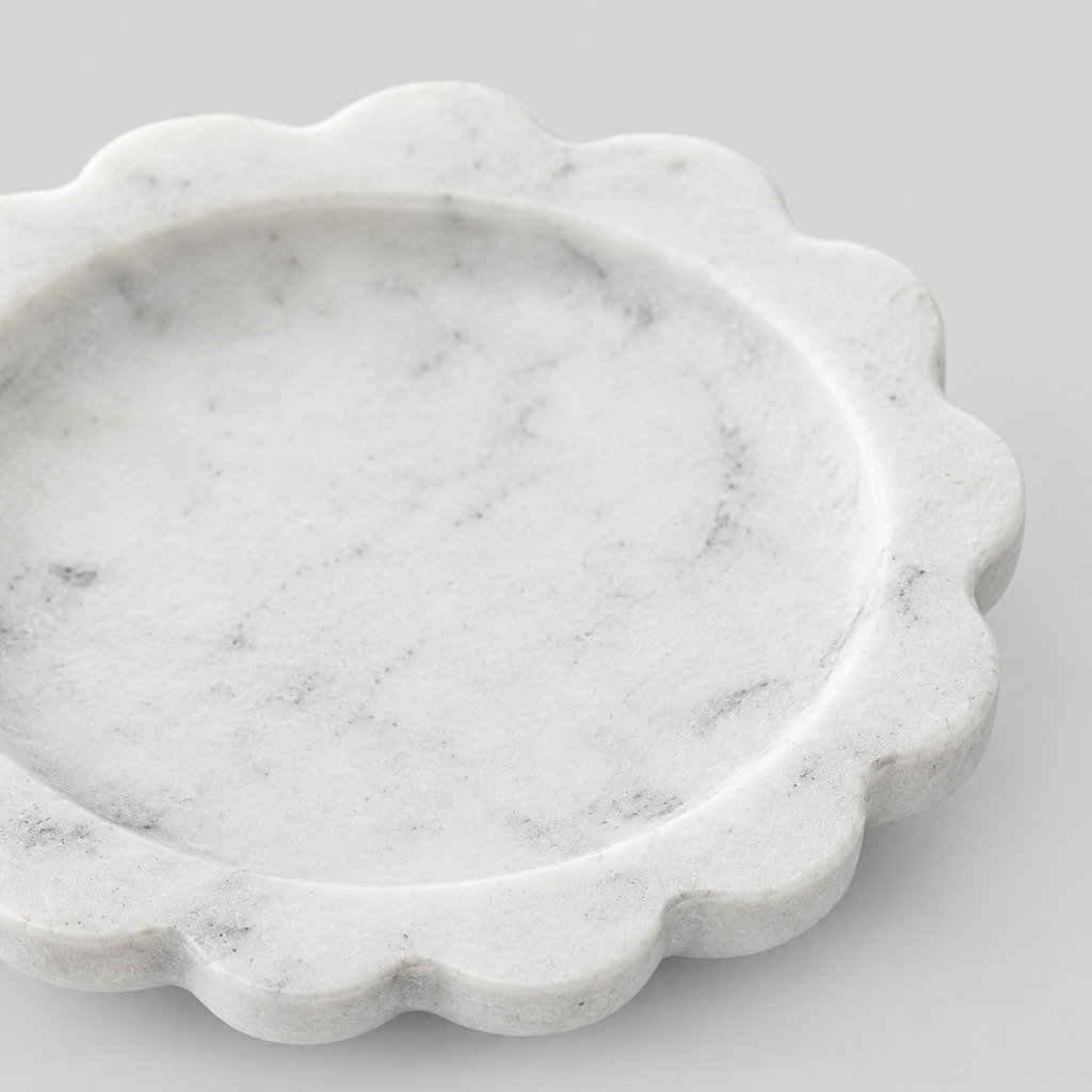 Close up of the scalloped fluted rim of the scalloped stone trinket tray in White Marble.