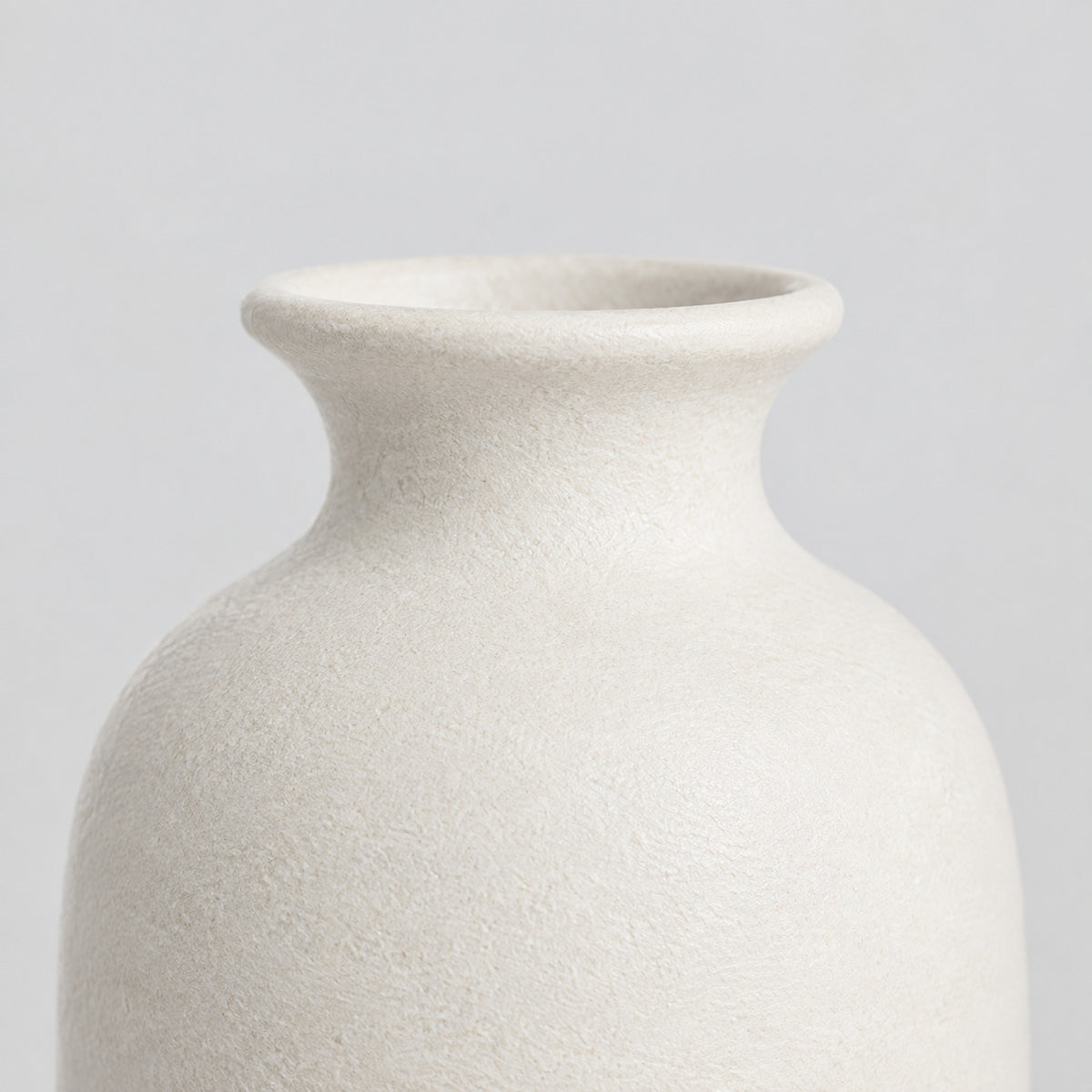 Close up of the tapered rim at the bottle neck of the Off-White matte ceramic bud vase.