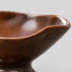 Close up of the undulating rim of the ceramic footed planter bowl in Glazed Brown.