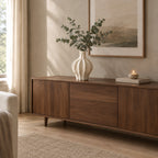 Coarse ceramic fluted vase in Speckled White on a walnut sideboard styled with eucalyptus stems.