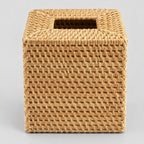 Natural rattan cube tissue box cover on a light gray studio background.
