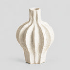 Coarse ceramic fluted vase in Speckled White on a light gray studio background, in its Large Fluted shape